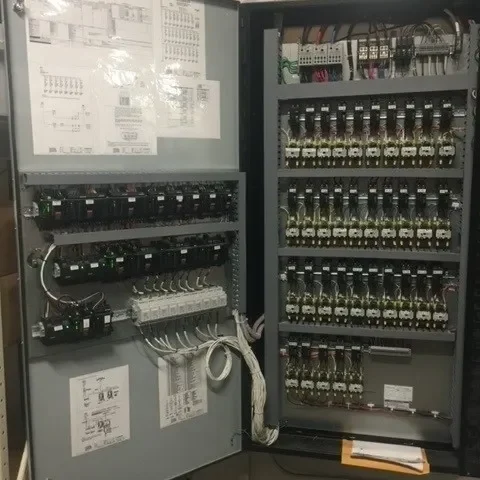 A large electrical panel with many wires and boxes.